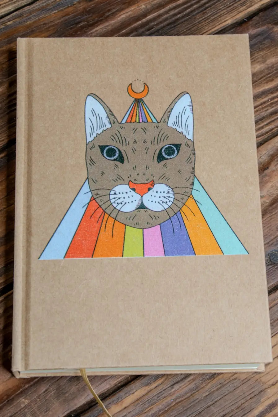 Magic Cat a5 Journal Sketchbook with a cat illustration on a wooden surface ©Glum Lot Press