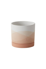 A small Vesper pot shown from the side with undulating shades of pink and white.