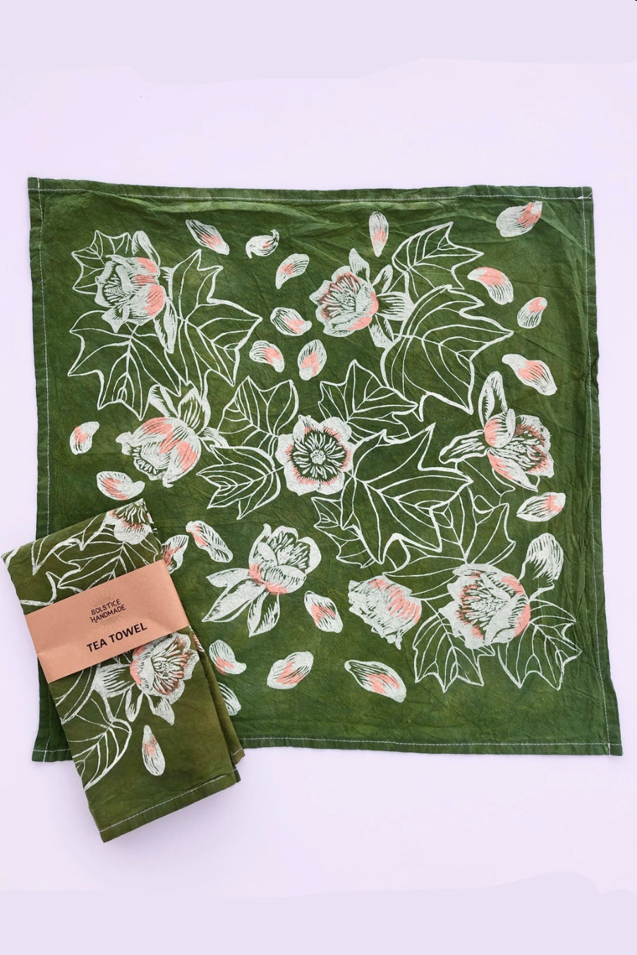 Green tea towel with floral pattern and packaging on a white background ©Solstice Handmade