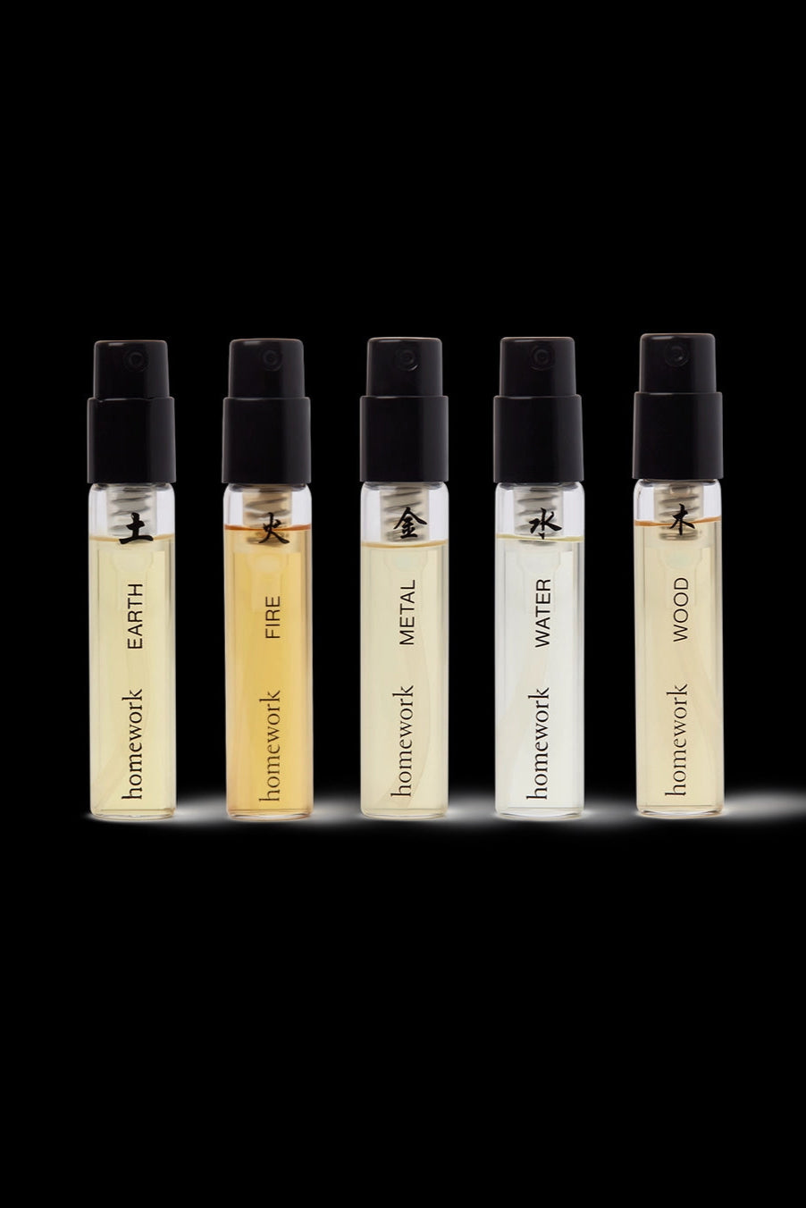Five Elements Fragrance Discovery Set Five small perfume bottles labeled 'Earth', 'Fire', 'Metal', 'Water', and 'Wood' on a black background. ©Homework
