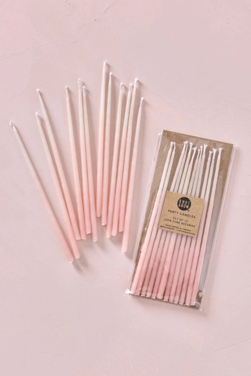 Knot & Bow Tall Ombre Pink beeswax candles in a package and out of a package.