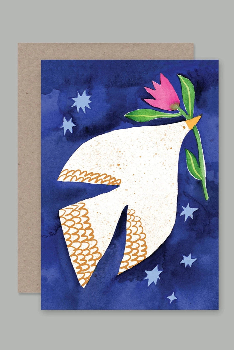 Dove card by AHD Paper Co showing the front of the card with a white. dove holding a flower in its beak on a blue sky background.