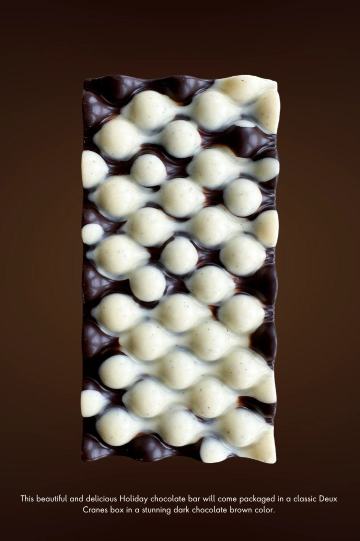 Dark Chocolate bar with Coffee and Cream with white chocolate balls on a brown background  ©Deux Cranes