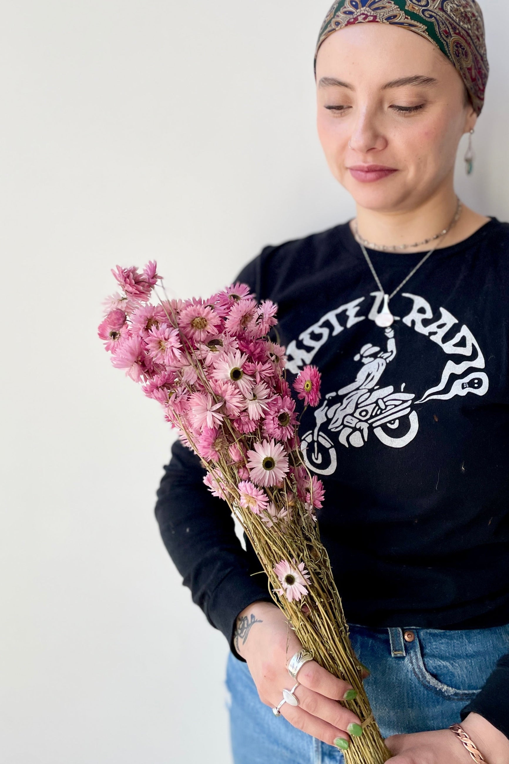 Acroclinium pink preserved bunch at SPROUT HOME being held by a sprout home associate.