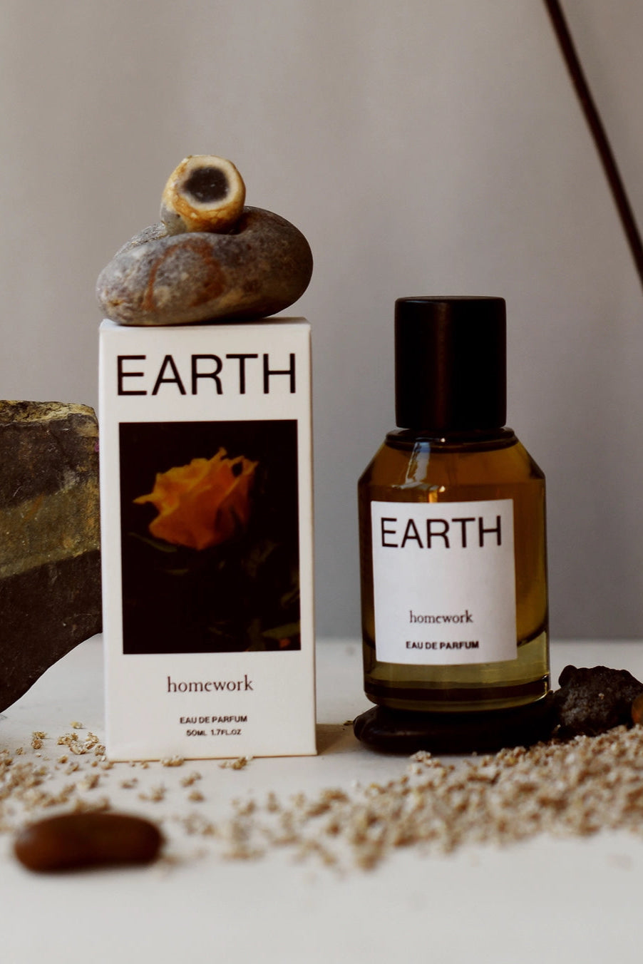 Earth Eau de Parfum Bottle and box of 'Earth' perfume with natural elements on a neutral background ©Homework