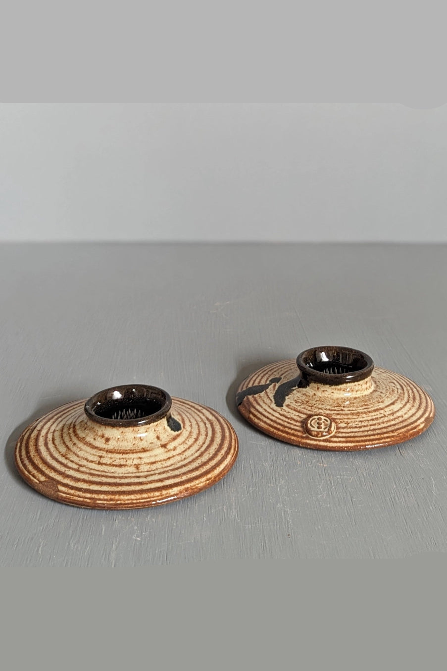 Two ceramic Ikebana bud vases with brown glaze on a gray surface ©South Creek Studios