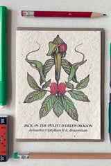 Jack in the Pulpit seeded at showing the front of the card surrounded by writing instruments 