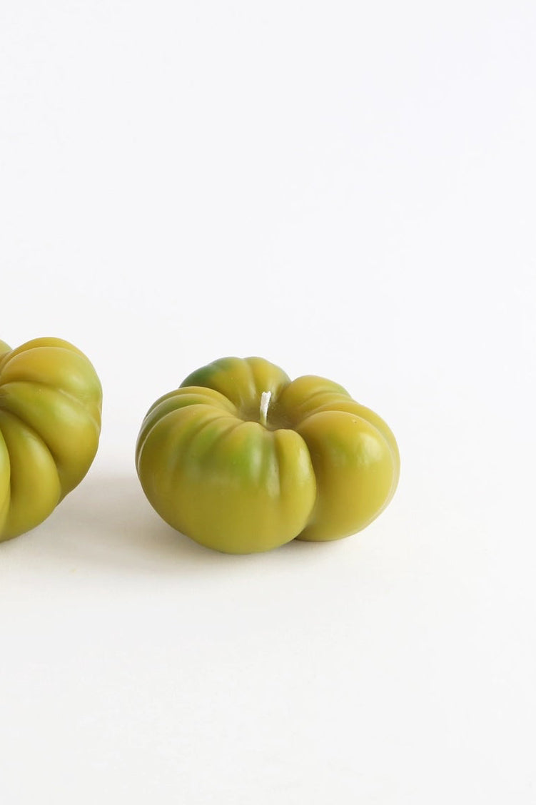 A green marbled tomato candle on a white background ©Artifaqt