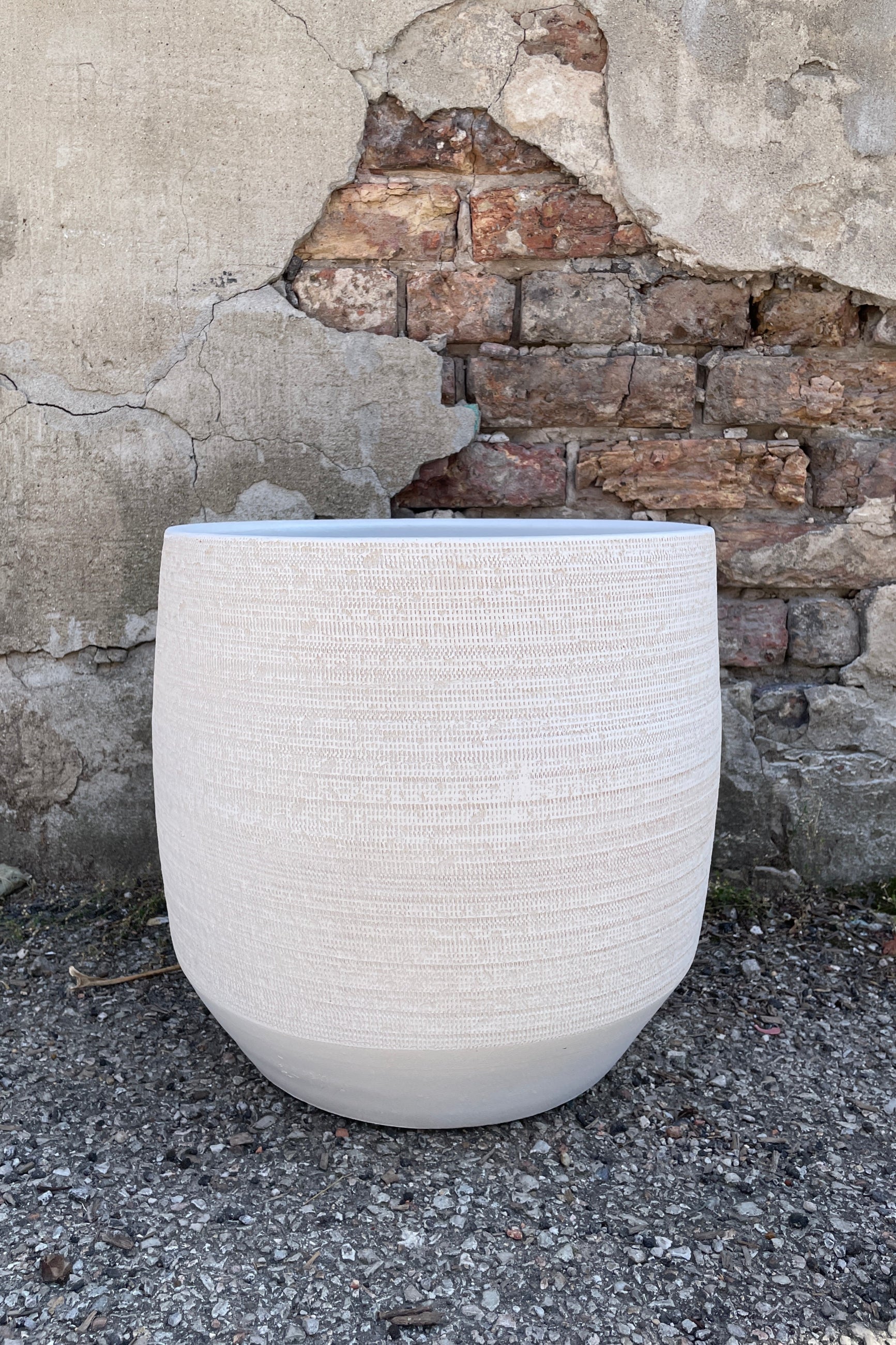 The White Ray Pot shown from the side at eye level showing the angled bottom