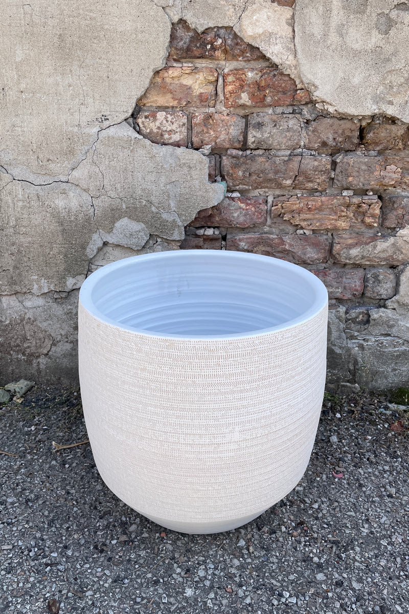 Ray pot white 13.5" shown from topside looking in sitting on a concrete floor