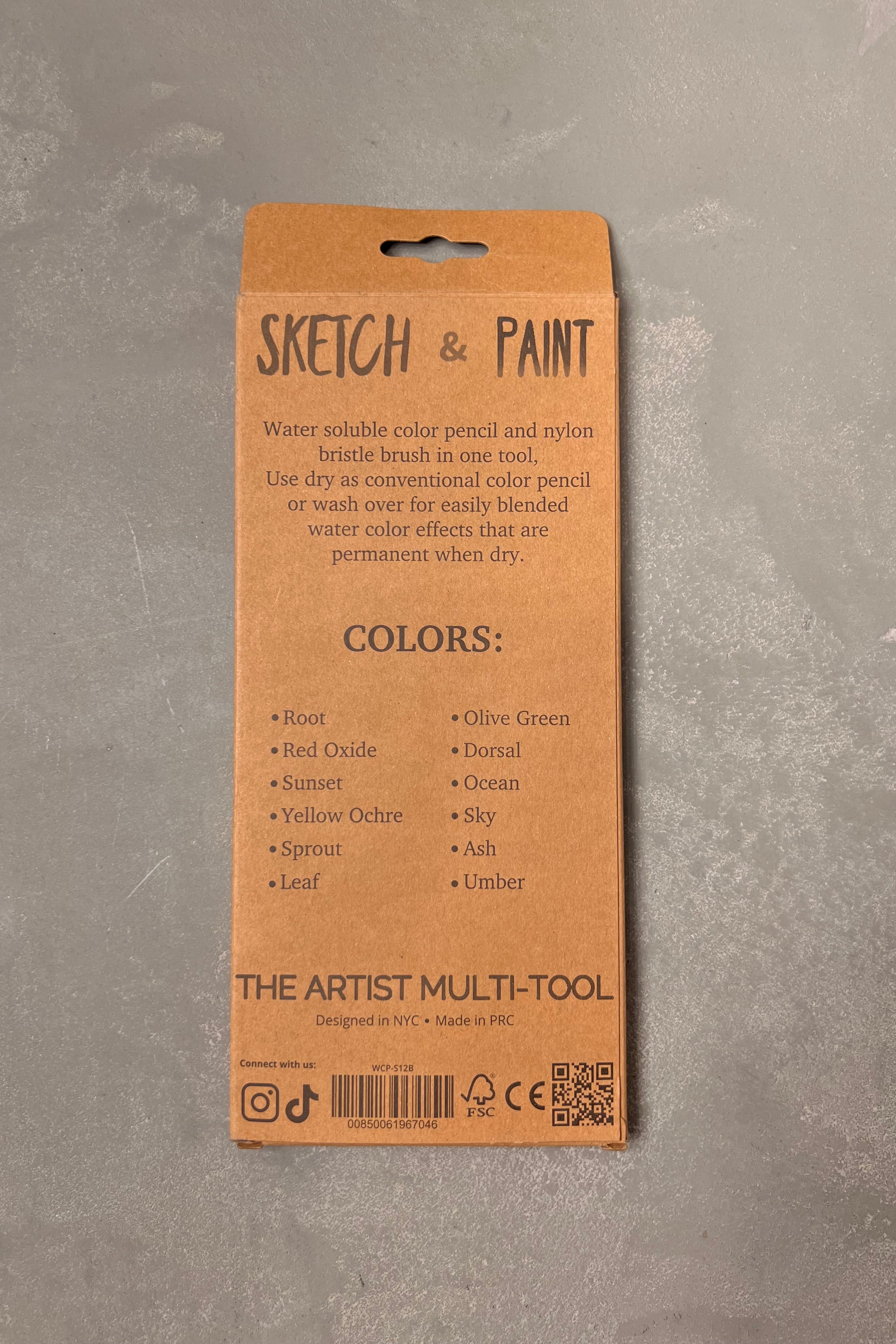 Back of a brown packaging box for 'Sketch & Paint' artist multi-tool on a gray background ©Mannahatta Pencil Co.