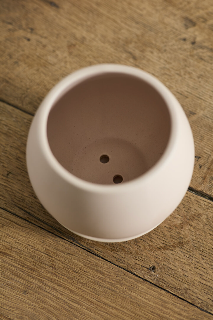 An overhead view into a ceramic pot on a wooden surface ©Accent Decor