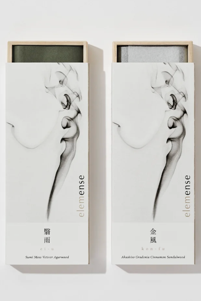 A pair of packaged of Yin and Yang incense sticks in front of a white wall ©Nippon Kodo