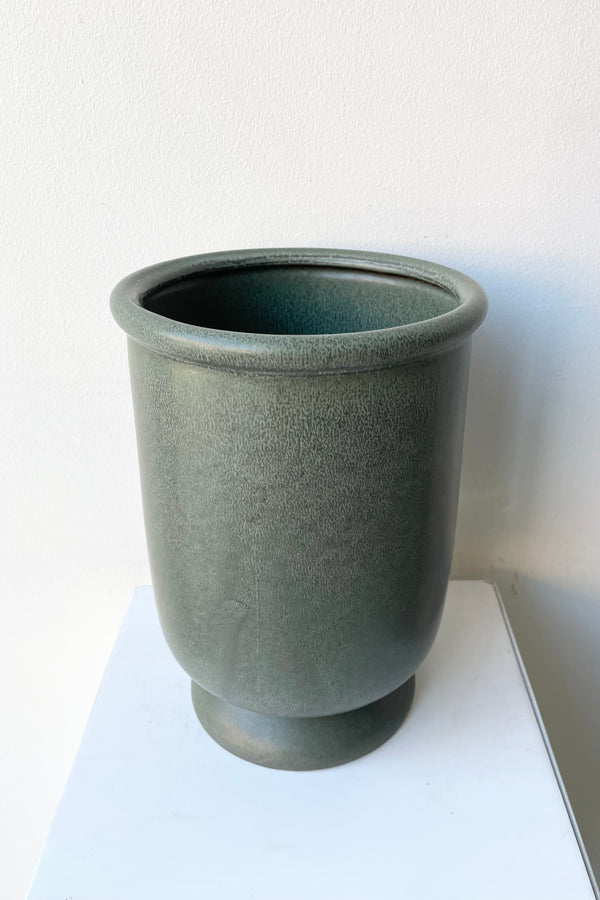 Stoneware dark green urn vase shown from above side looking slightly in.