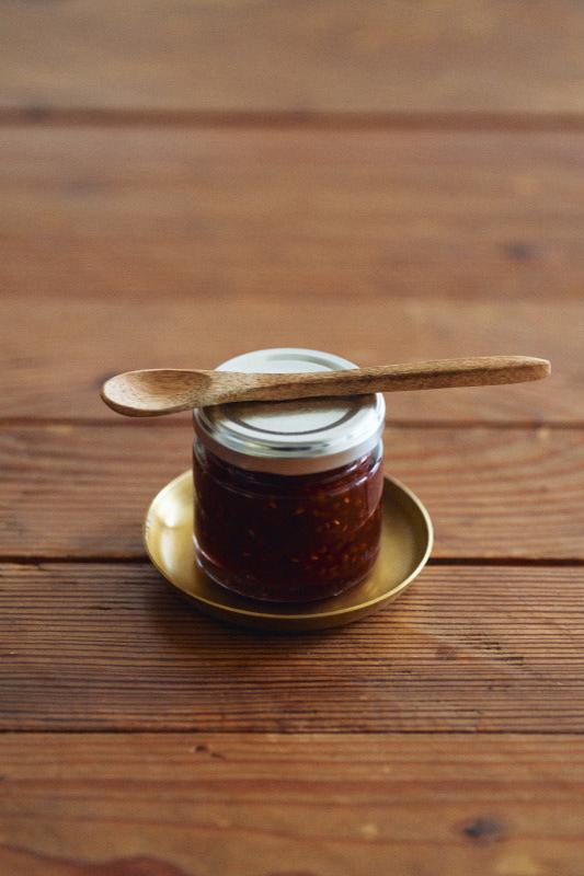 Extra Small brass plate by Fog Linen Work with a jar of jam and a wood spoon sitting on top