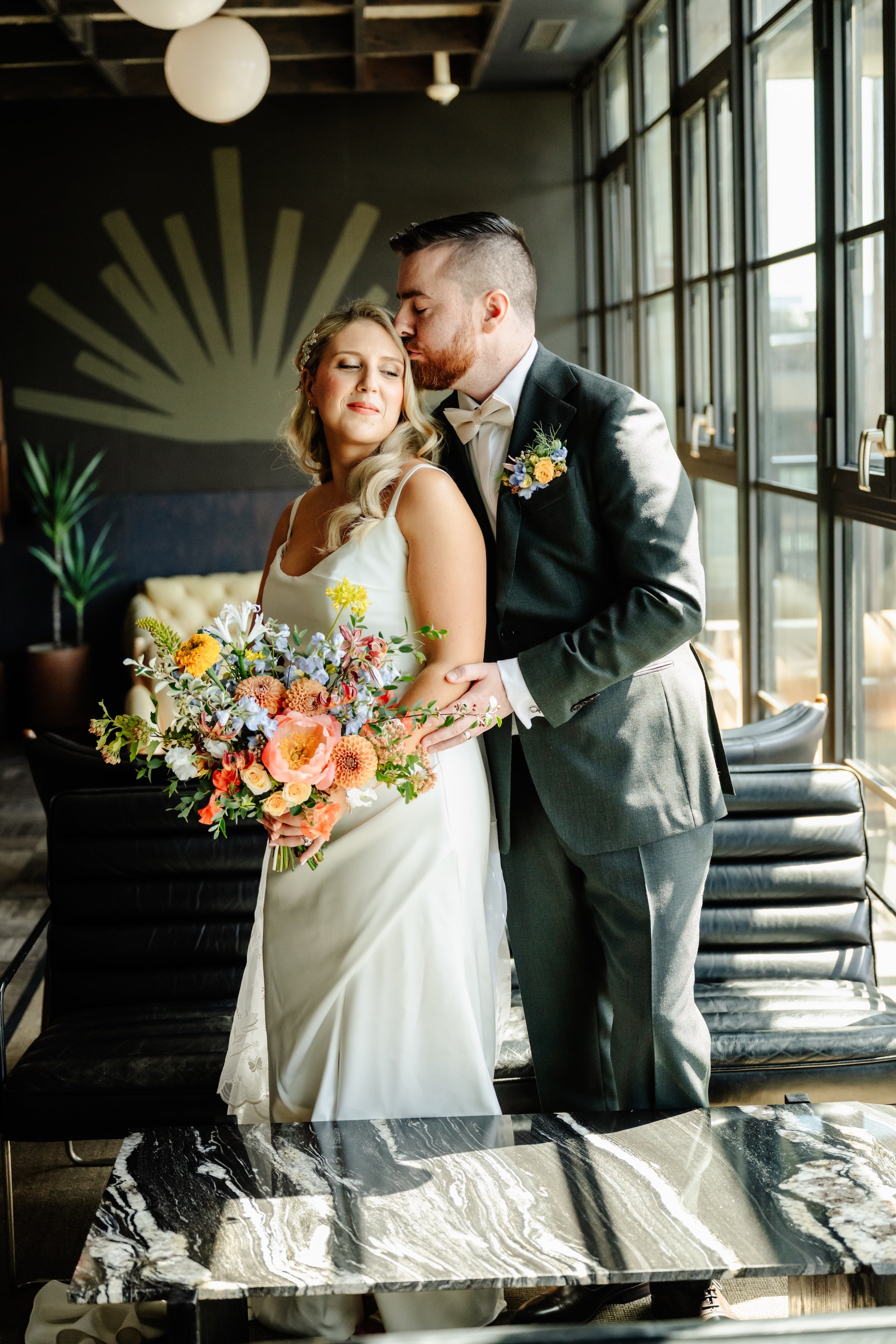 Couple embracing at The Arbory in Chicago. Floral by Sprout Home ©Joy by o