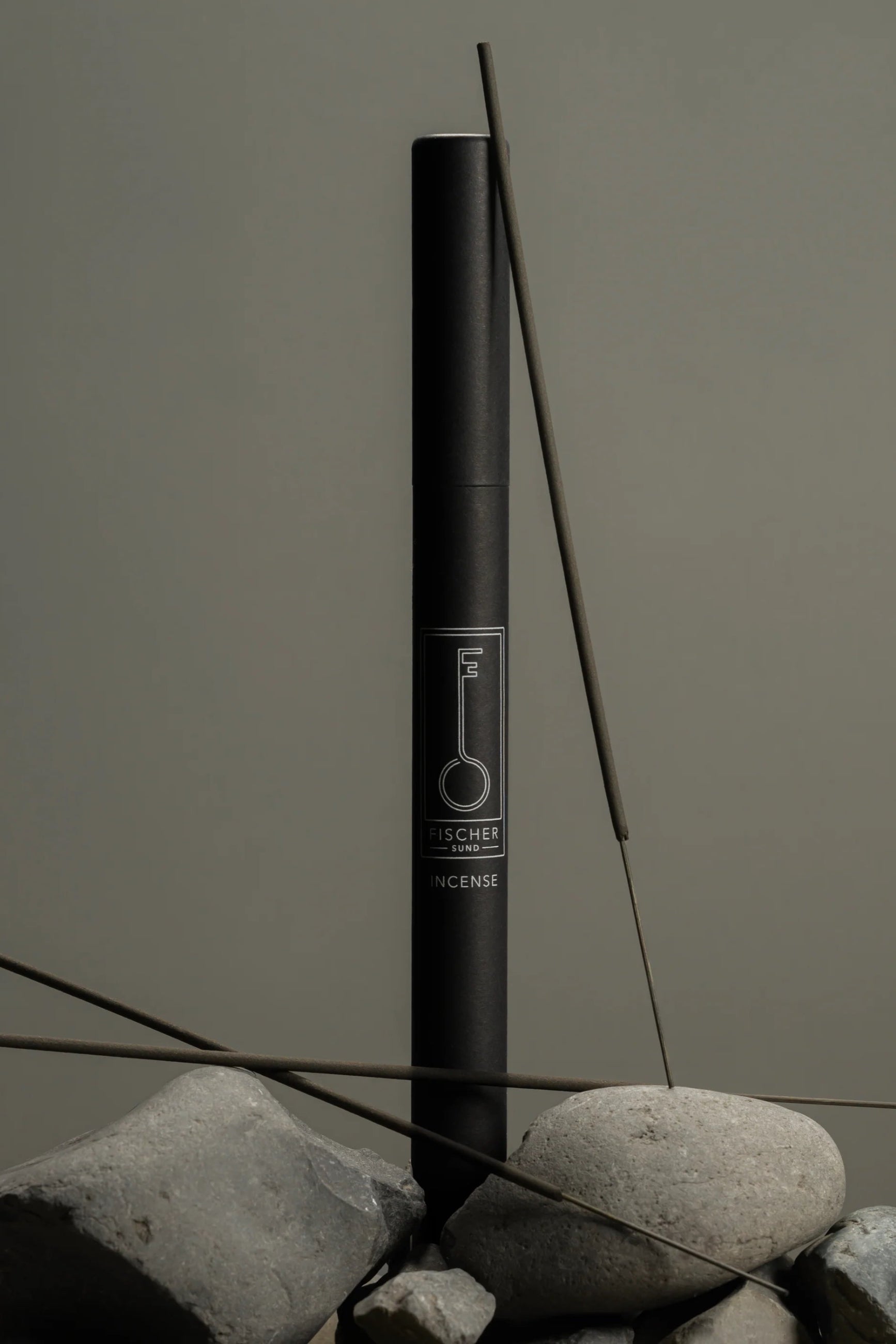 Fischersund Incense Sticks with incense sticks and packaging on gray stones against a gray background ©Fischersund