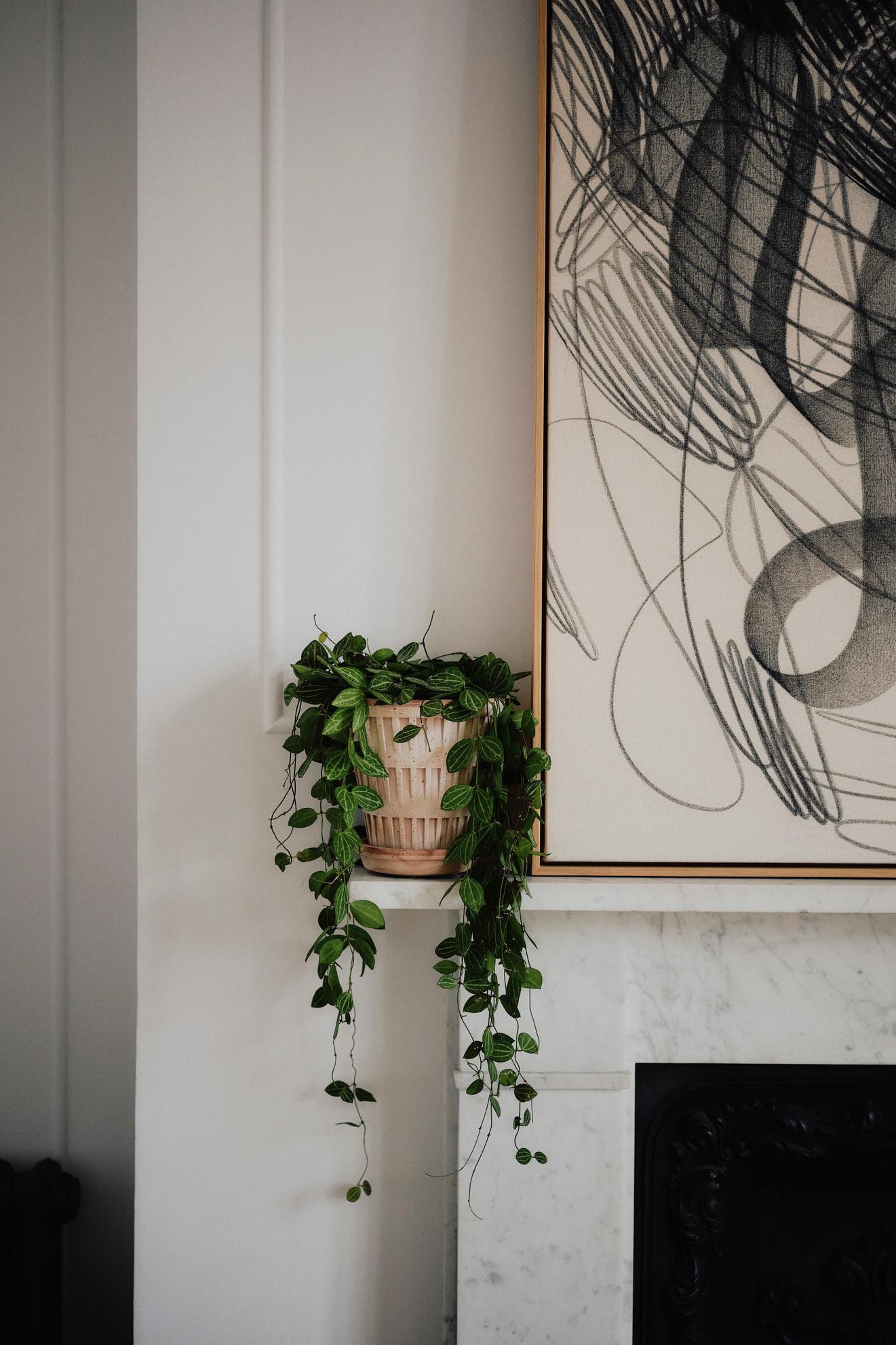 Bergs Potter Raw Pantheon pot on a fireplace mantle next to a black and white abstract painting ©Bergs Potter