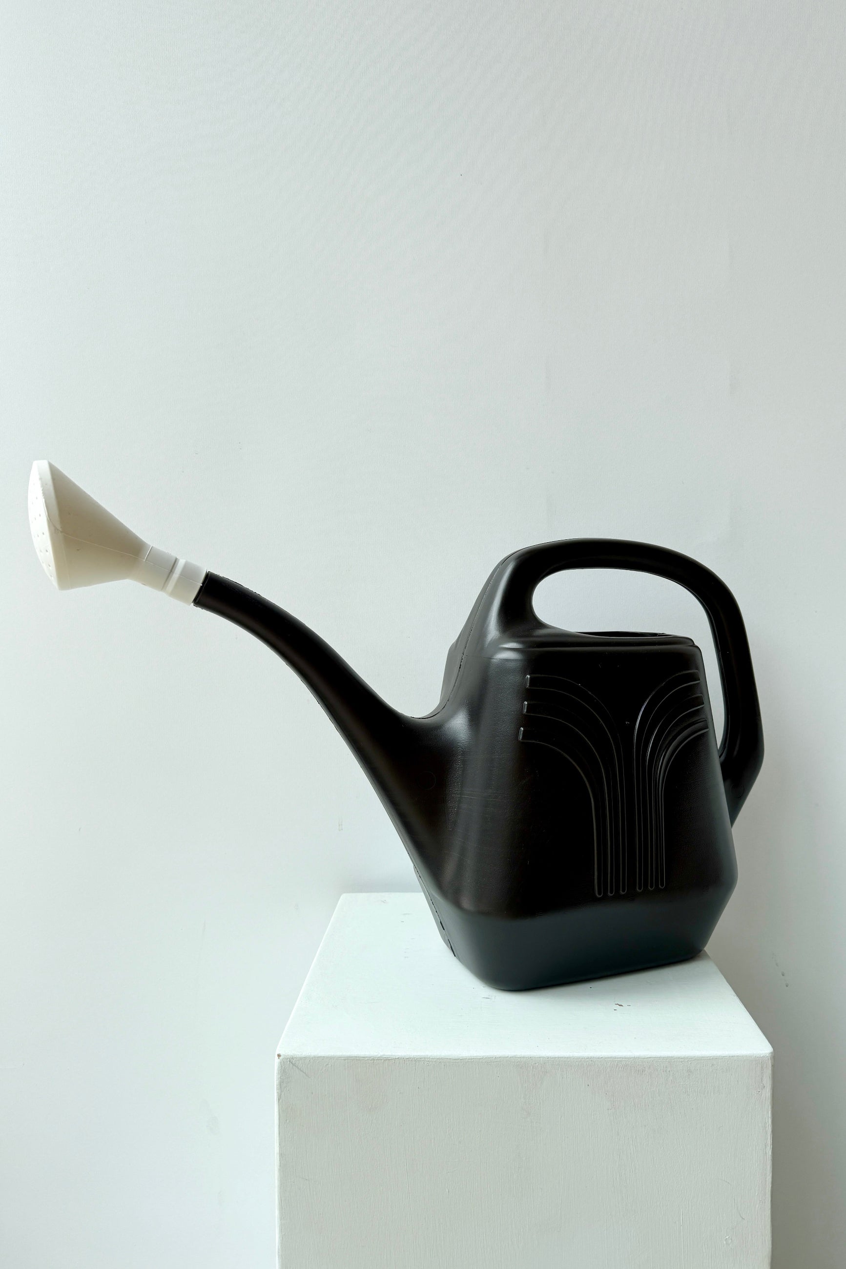 Promo black 2 gallon watering can shown from the side front corner ©Sprout Home