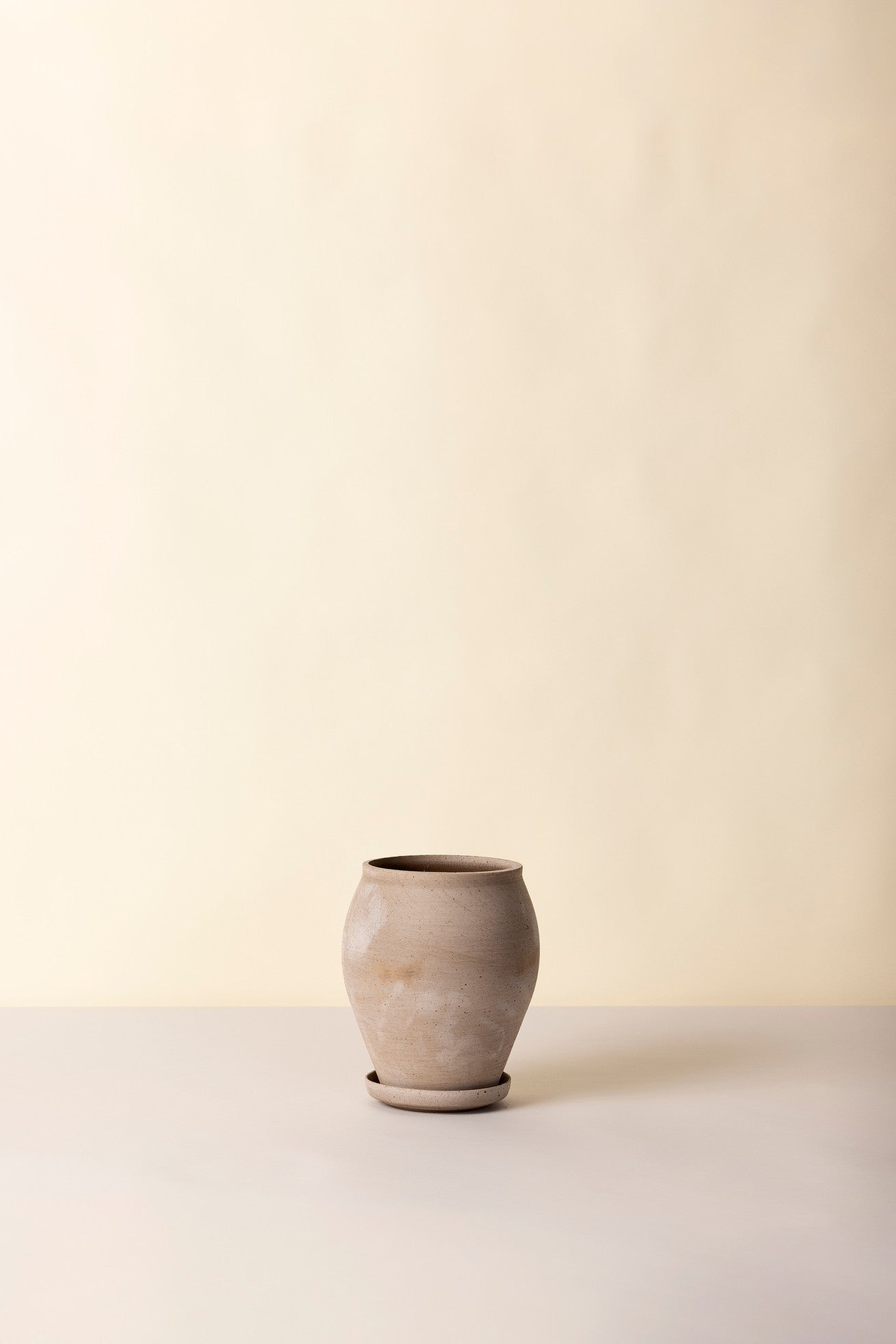 tall grey Delphi ceramic vase on a light beige background ©Bergs Potter