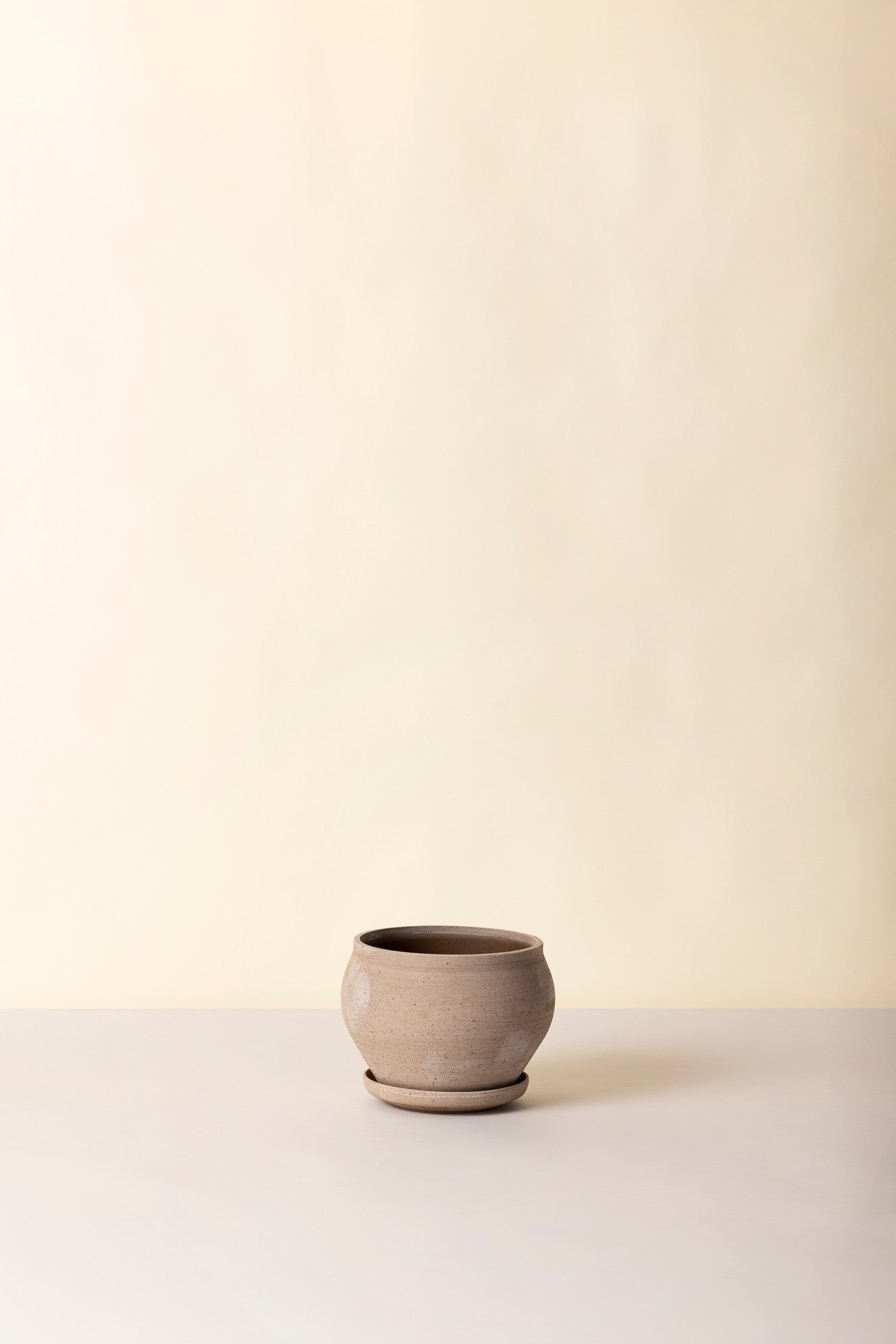Delphi raw planter, empty, and sitting against a offwhite backdrop ©Bergs Potter
