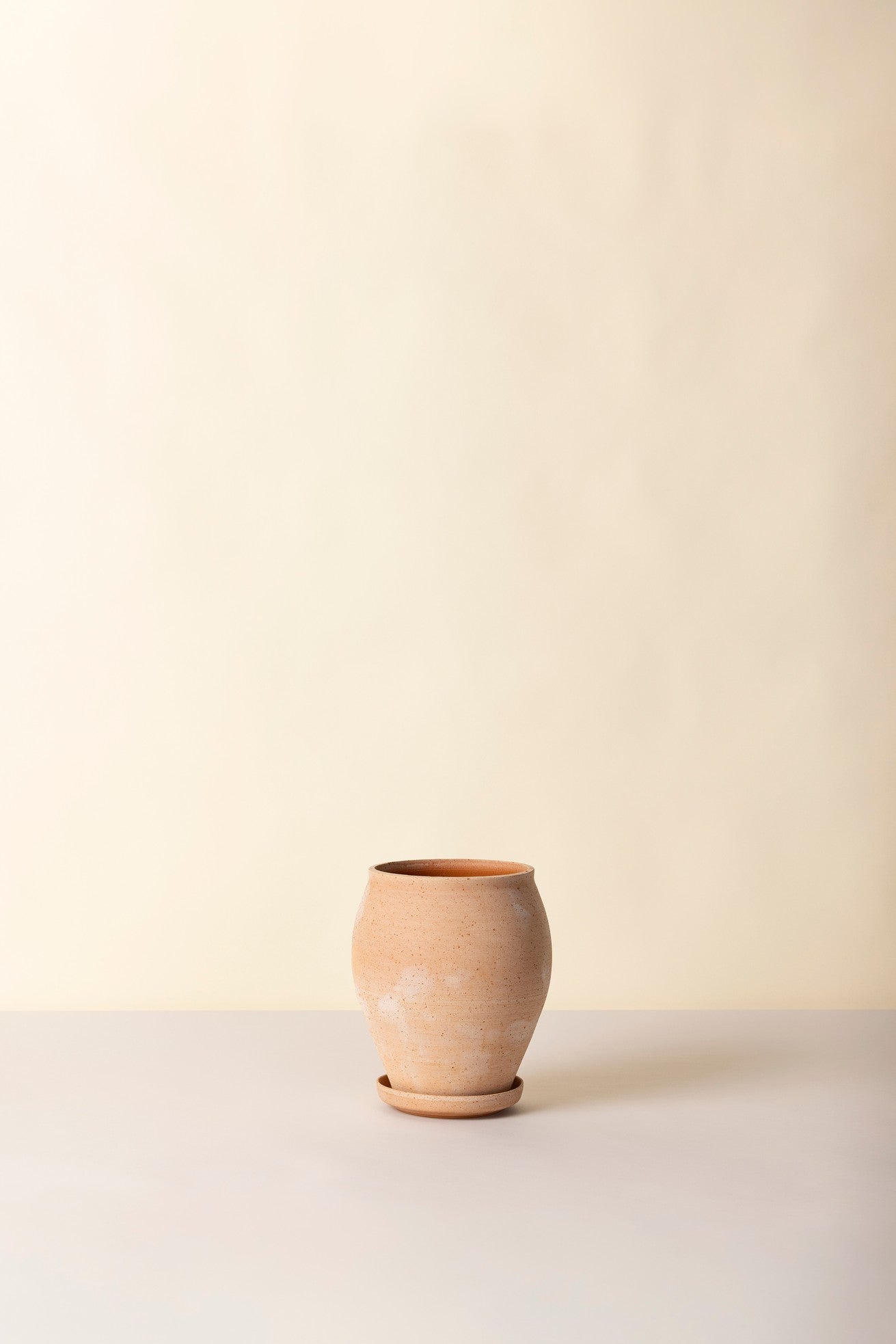 Terracotta rosa Delphi Tall pot on a light surface with a beige background ©Bergs Potter