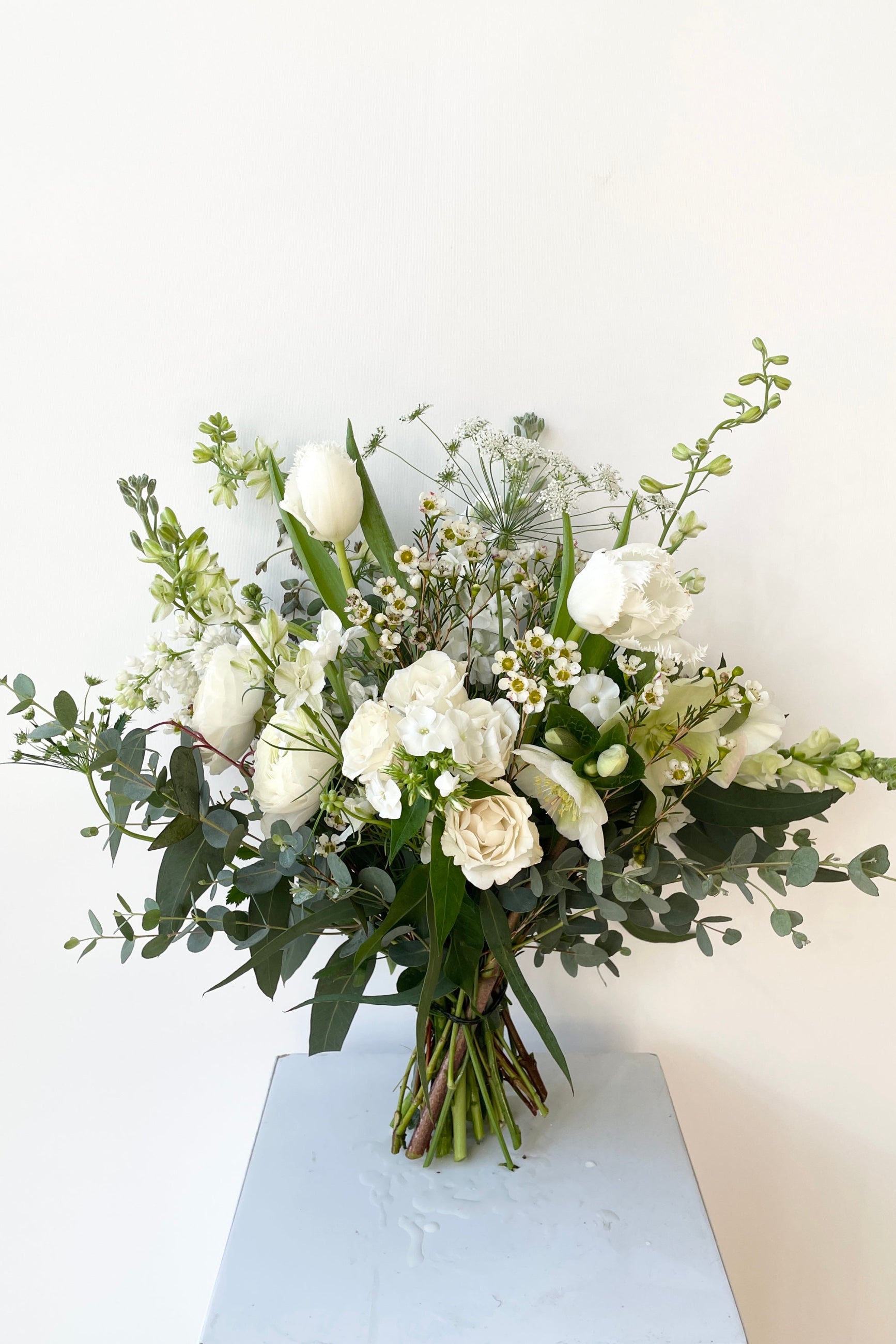 Bleached floral arrangement by Sprout Home in February featuring white roses. ©Sprout Home #size_$100