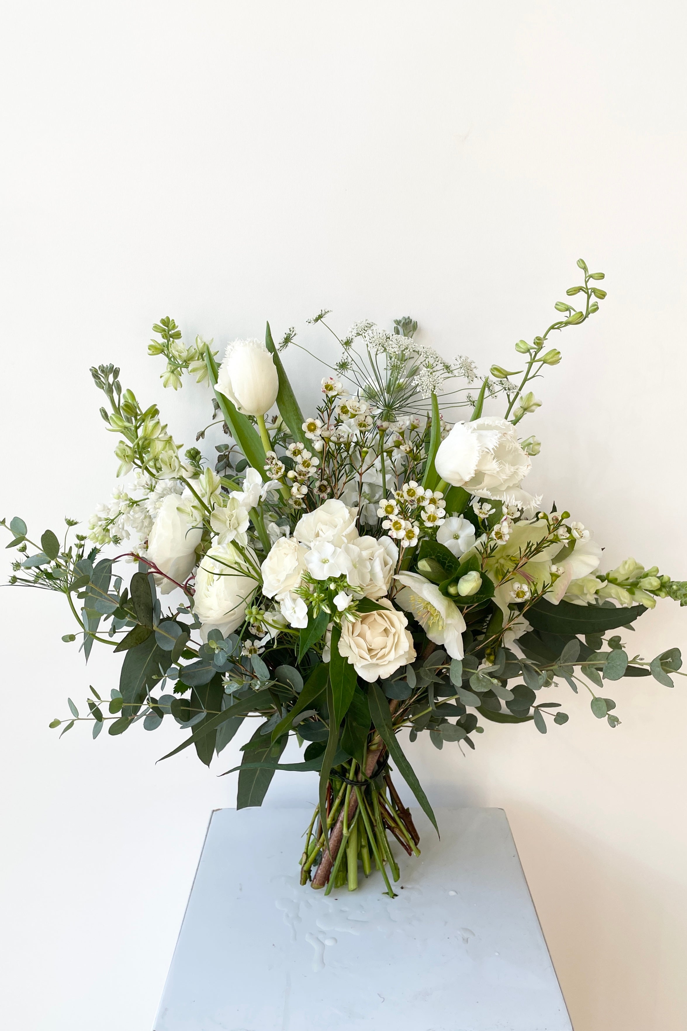 Bleached floral arrangement by Sprout Home in February featuring white roses. #size_$90