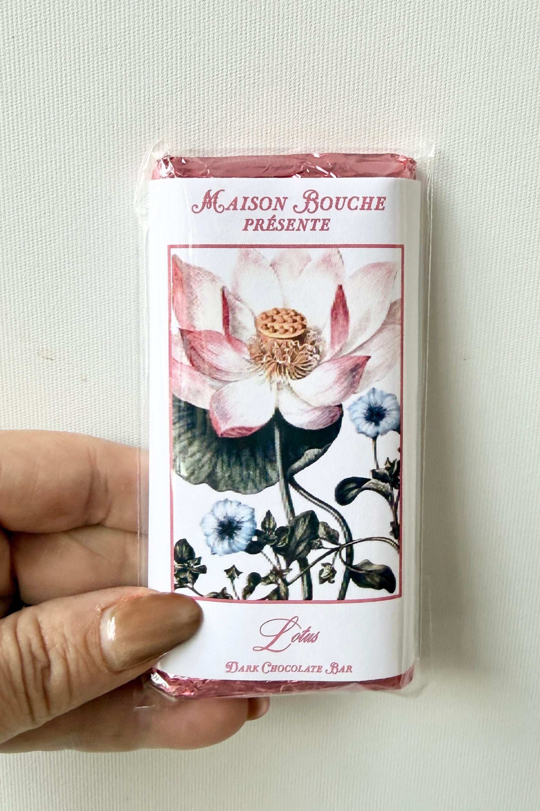 Hand holding a Maison Bouche chocolate bar packaging with floral design ©Sprout Home