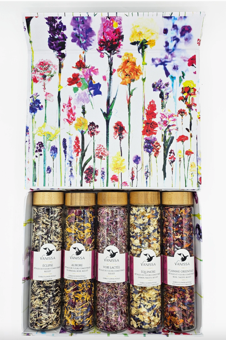 A photo of a white box with colorful floral imagery holding five glass cylinders of colorful flower petals. Shown on a white background.