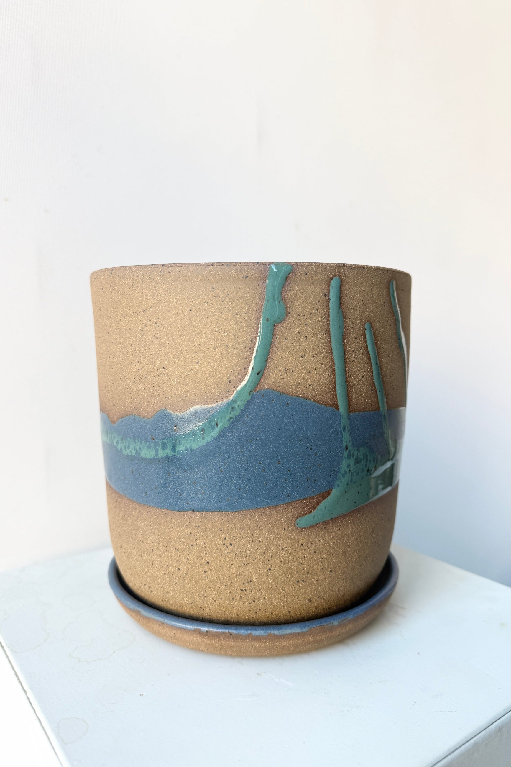 Cylinder Pot & Saucer Denim and Dark Teal Splash Glaze 6.5" handmade by Christina Kosinski on a white surface ©Sprout Home