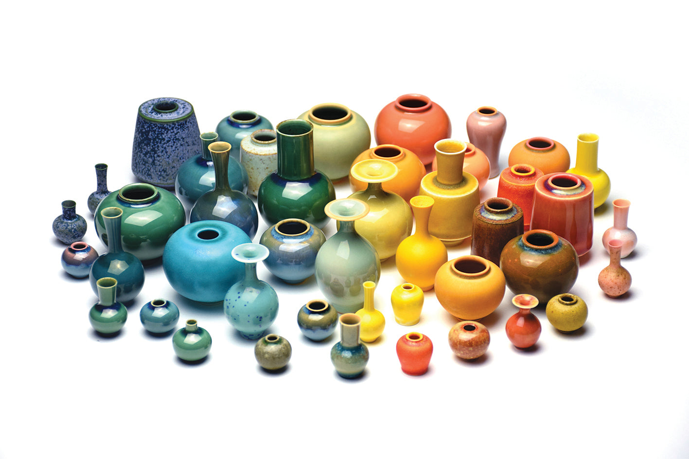 Assorted colorful ceramic vases on a white background ©SGW Lab