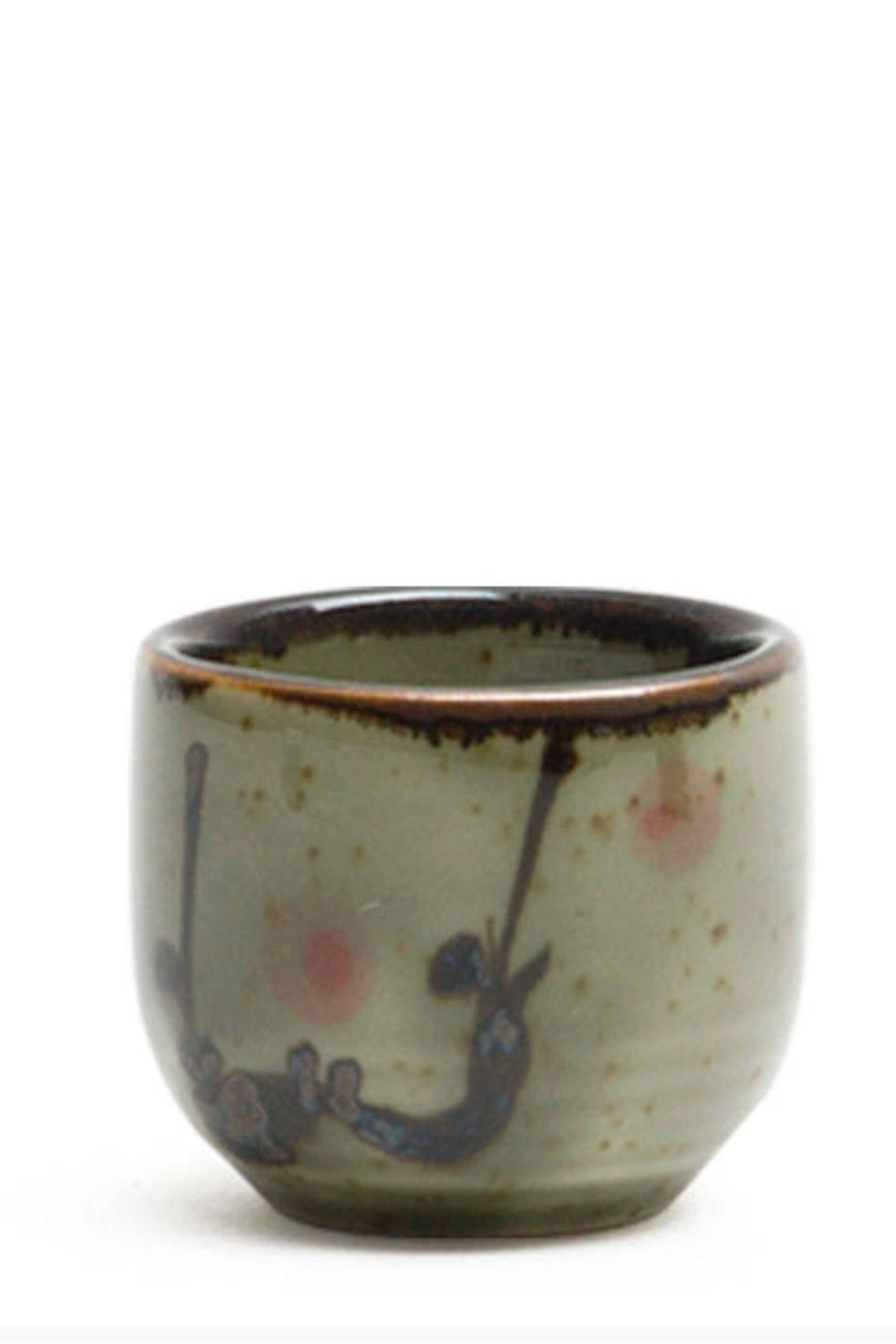 A ceramic cup with abstract glaze on a white background ©Miya Company