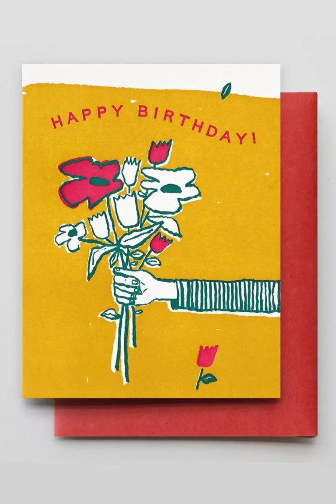 A yellow and red greeting card with a drawing of a hand holding flowers and the text "Happy Birthday!" ©Hammerpress
