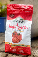 A full view of Espoma Tomato-Tone 4lb surrounded by plants