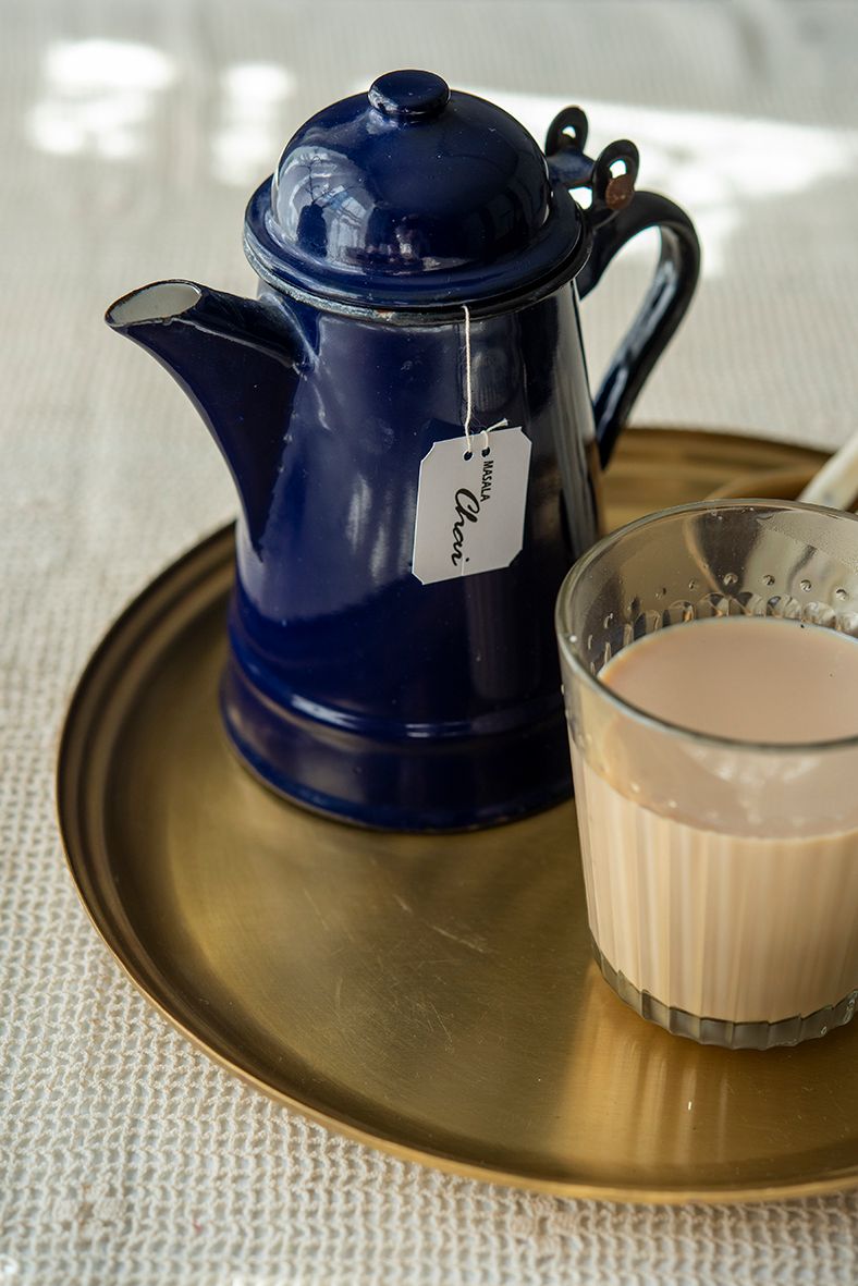 Brass Plate by Fog Linen Work with a blue Tea cup and glass with milk. 