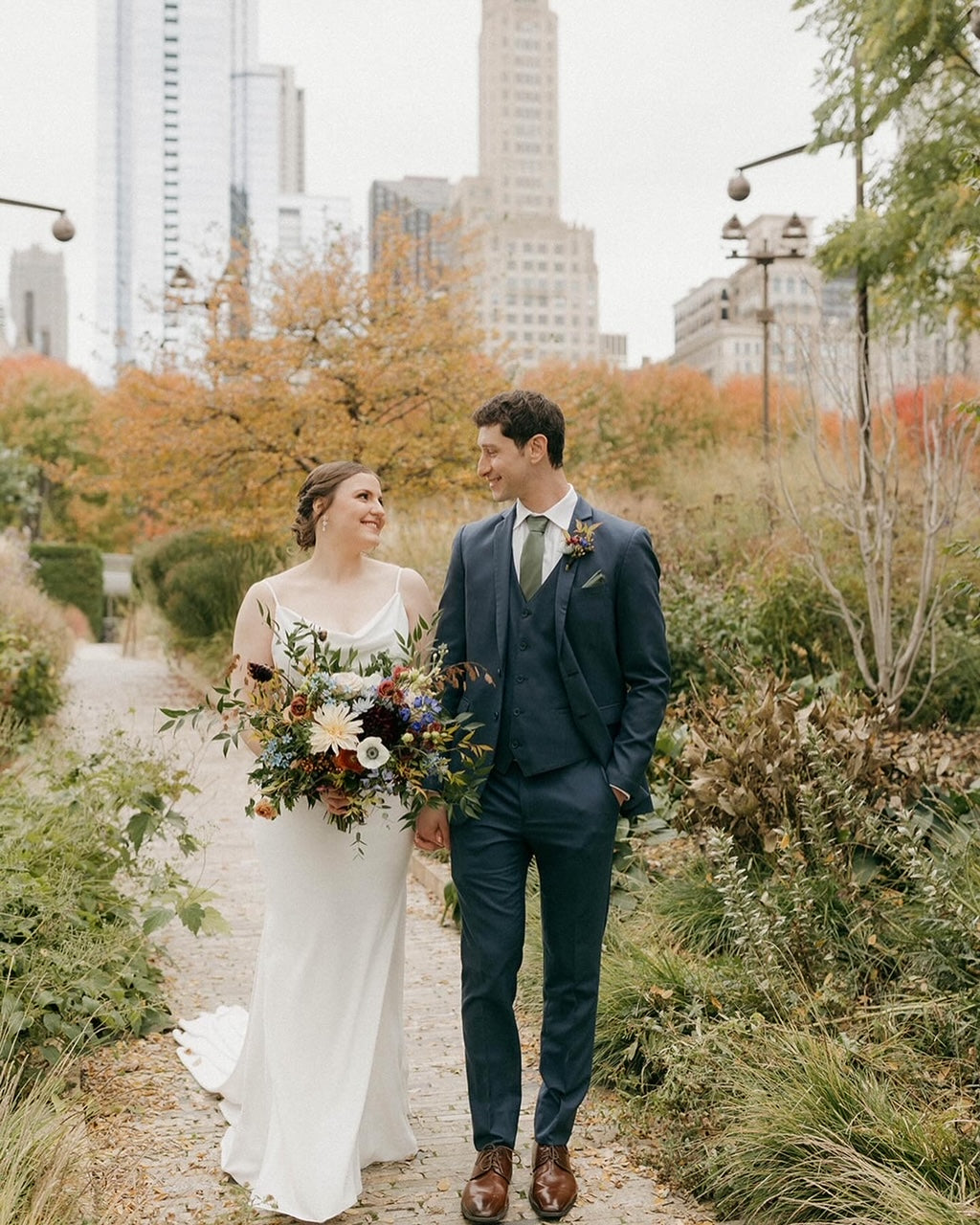 Sprout Home wedding bouquet in all colors being held in hand by Emma the bride. Photograph by Lauren Sims Photo