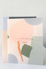 A full frontal view of Celebrating You Card with envelope against white backdrop