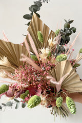 Detail picture of 'Faerie' preserved arrangement with dried neutral palm and shades of pink and mint. 