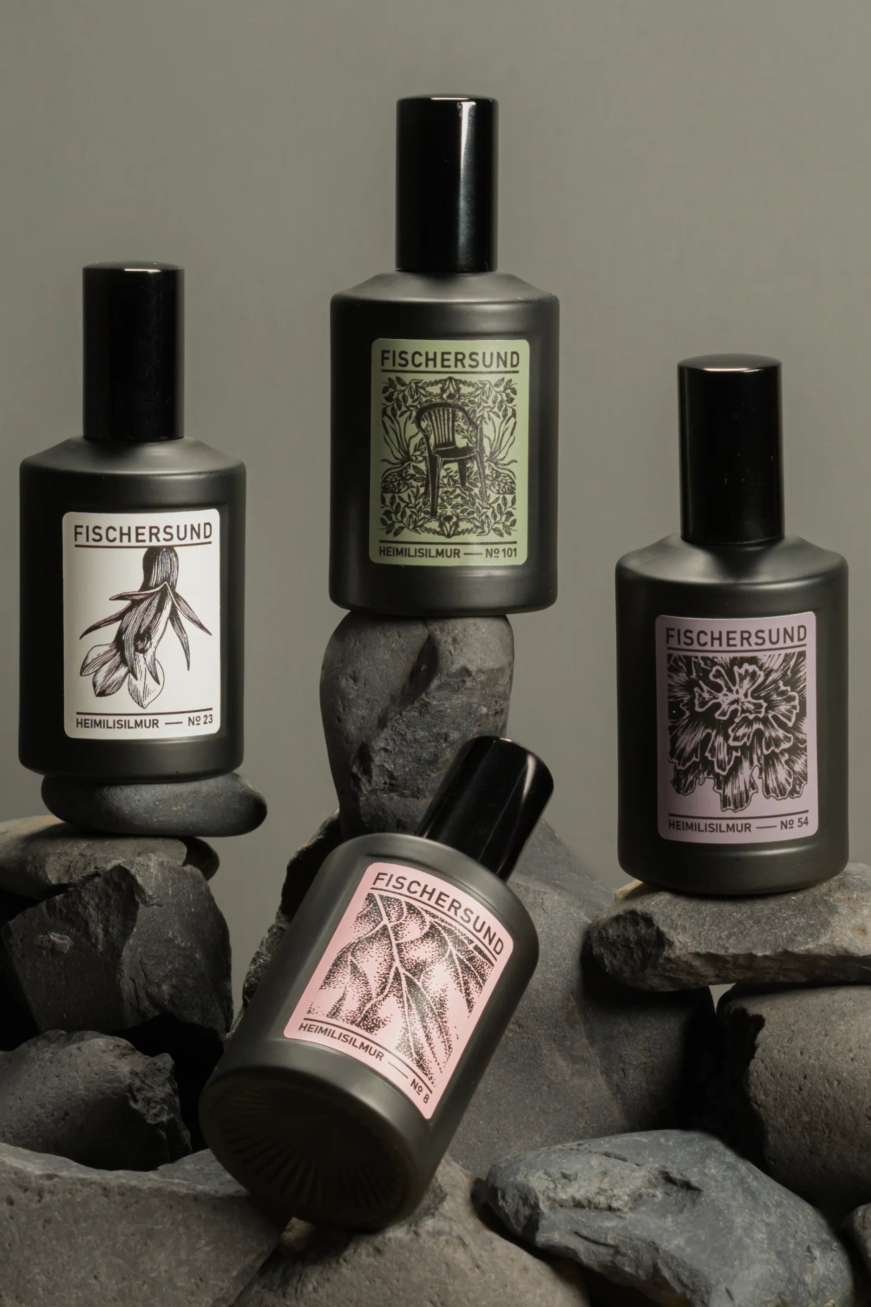 Four Fischersund room spray bottles on stones with a neutral background ©Fischersund