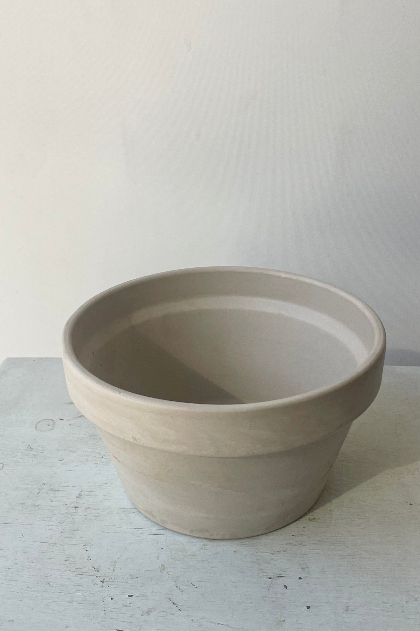 A shallow white pot in a white room. Looking down into the pot ©Sprout Home