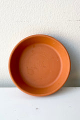 Cute mini clay saucer to fit a standard 2.8 clay pot sitting on the side.