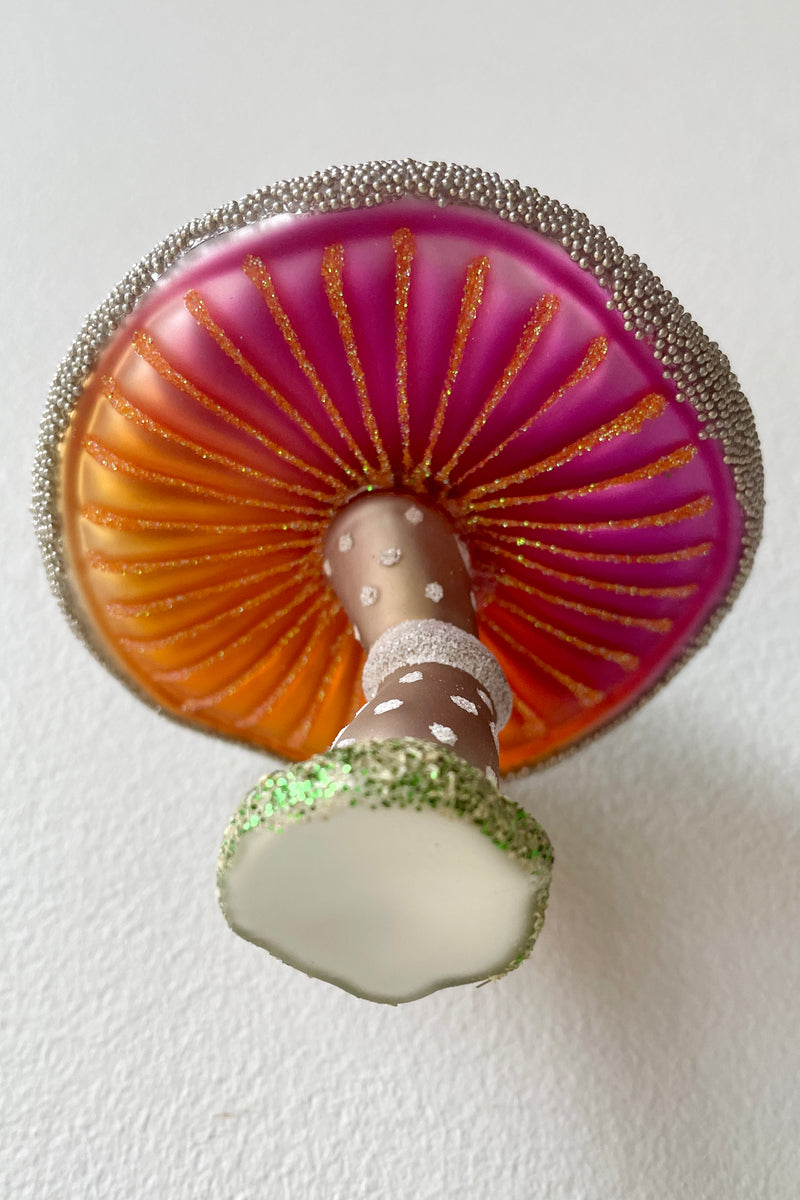 The underside of the Purple Wooded Glen Mushroom ornament with vivid brand and fuchsia at Sprout Home. 