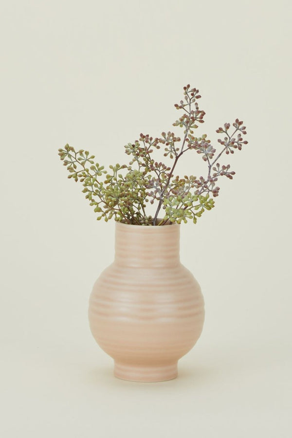 Essential Blush vase with eucalyptus seeded branches inside.