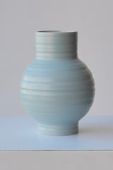 A small size Sky colored Essential ceramic vase by Hawkins NY viewed from the side at eye level. 