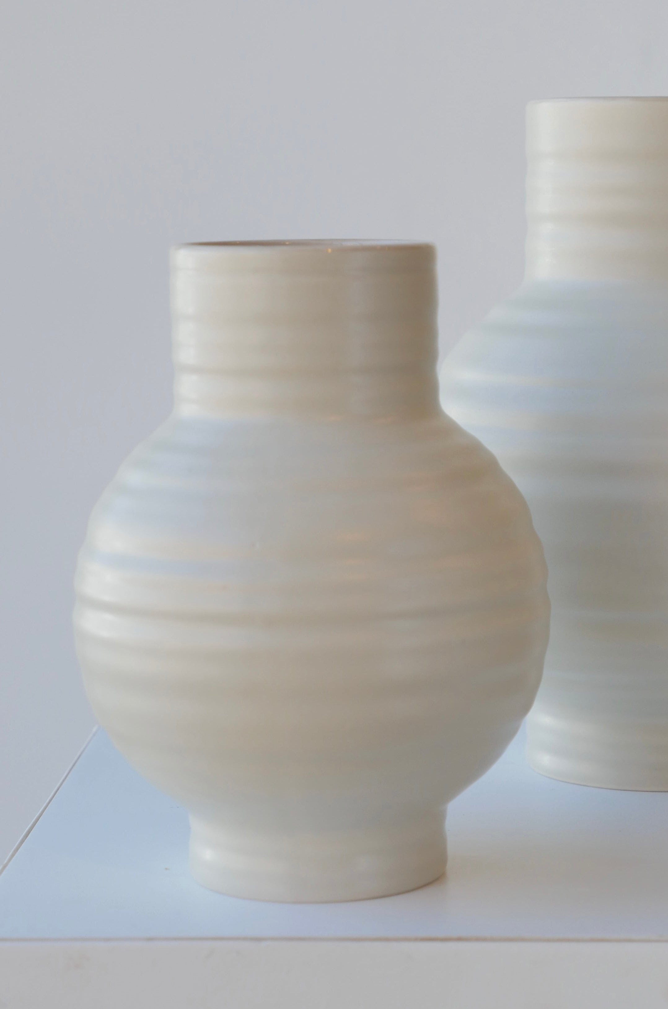 A pair of Essential light grey ceramic vases by Hawkins NY