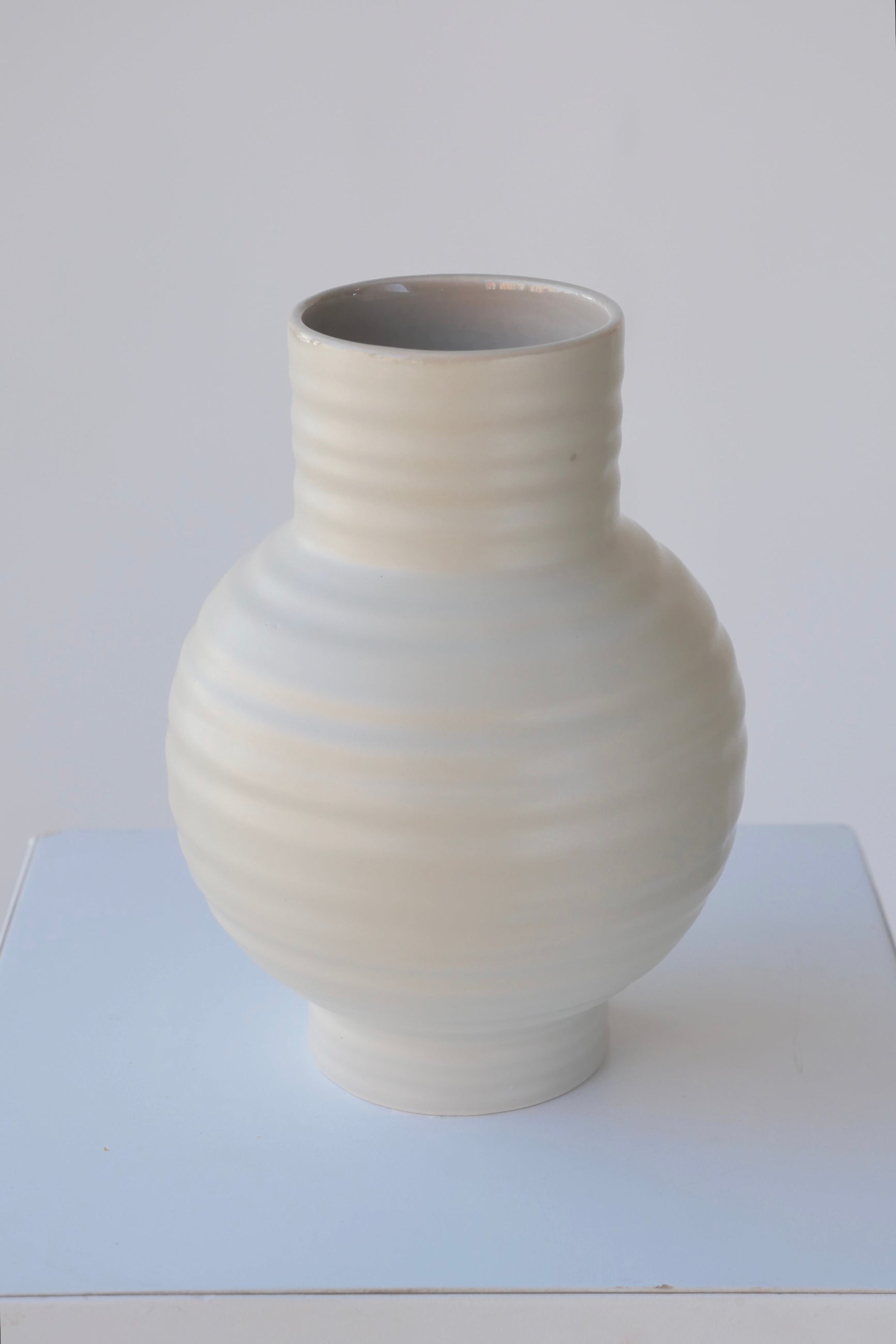 Essential Light Grey ceramic vase in Large showing the horizontal ridges.  ©Sprout Home