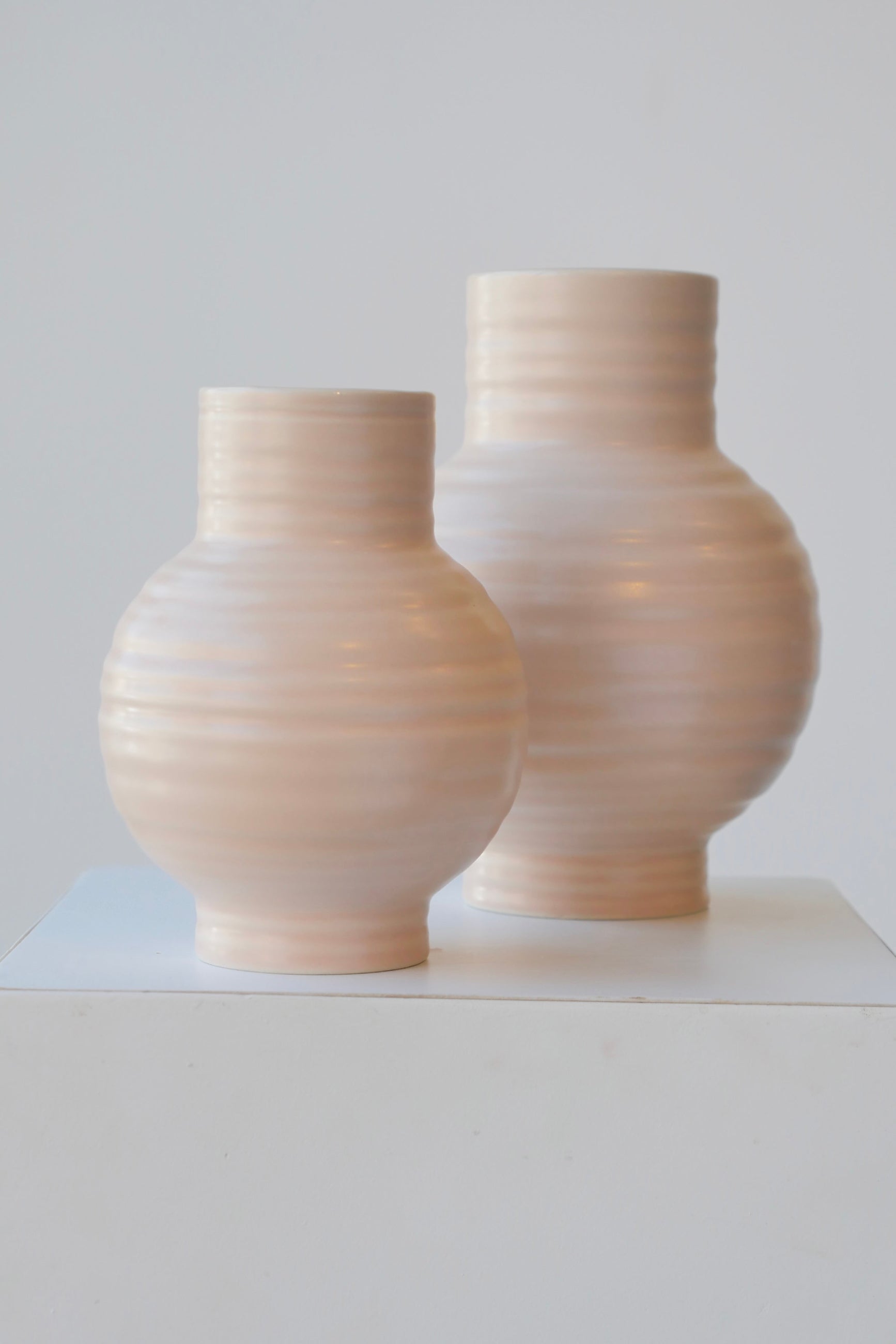 Blush Essential vases in two different sizes with the small in front.   ©Sprout Home