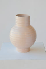 Large essential vase in Blush color by Hawkins New York against white.