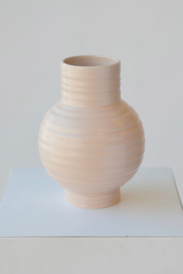 Large essential vase in Blush color by Hawkins New York against white.